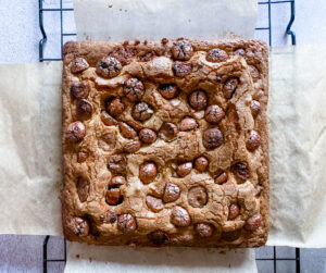 Add the chocolate eggs to the top of the blondie | Cook Simply