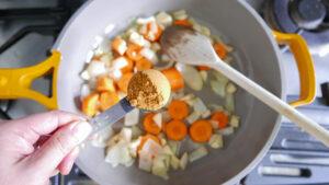 Adding curry powder to onions, garlic and carrots - Cook Simply