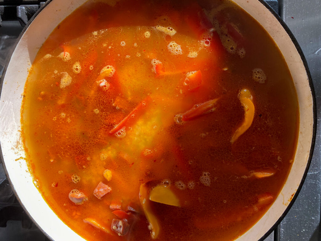 Adding stock to the Spanish chicken - Cook Simply