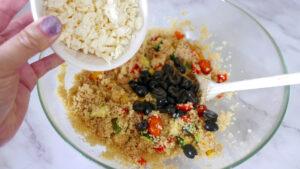 adding feta and olives to couscous salad - cook simply