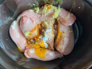 Putting ingredients in slow cooker for chicken curry - Cook Simply