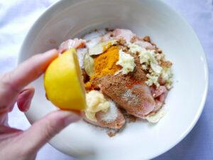 marinating chicken thighs with spices and lemon juice - Cook Simply