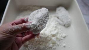 Dredging chicken wings in corn flour - Cook Simply