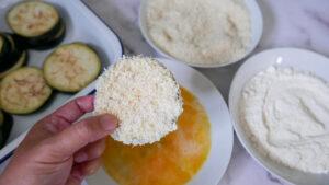 Coating aubergine in parmesan breadcrumbs - Cook Simply
