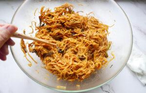 adding the soy mixture and spring onion oil to the noodles - Cook Simply