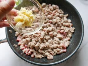 Adding garlic and herbs to sausage meat - Cook Simply