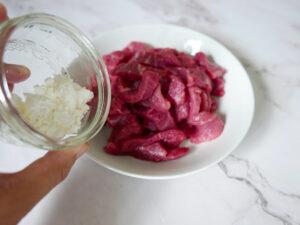 Adding cornflour to beef steak strips - Cook Simply