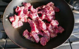 Stir frying beef strips in a wok - Cook Simply