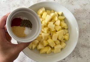 Adding seasoning to diced potatoes - Cook Simply