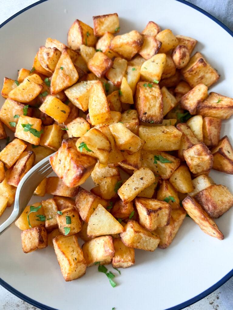 diced air fryer potatoes sprinkled with parsley - Cook Simply