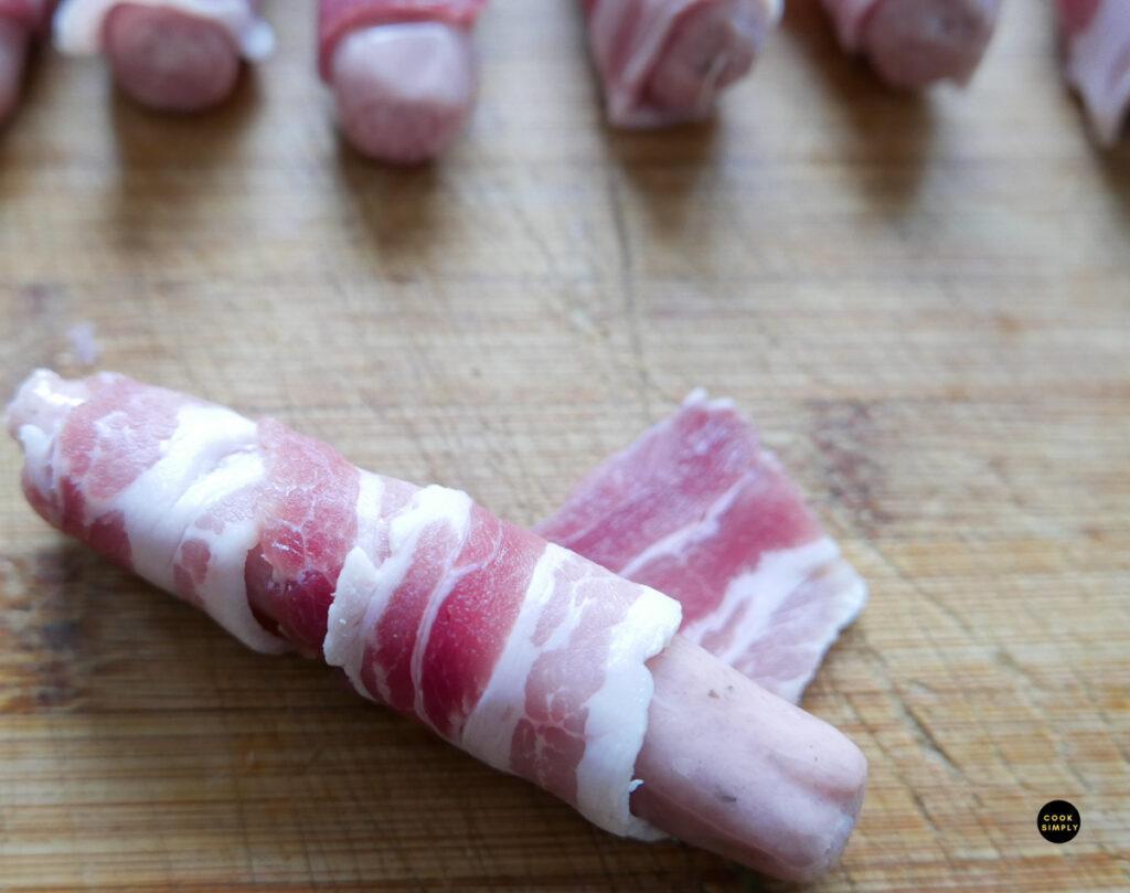 Wrapping sausage with bacon - Cook Simply